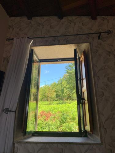 a window in a room with a view of a field at Casa de Costoia in Santiago de Compostela