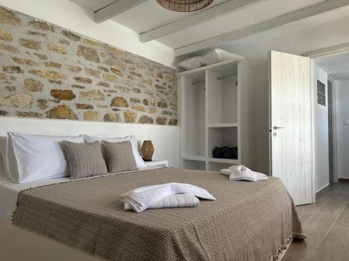 a bedroom with a bed with two towels on it at Nature & Sea Lipsi in Lipsoi