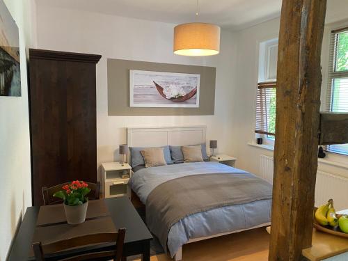 a bedroom with a bed and a table in it at Ferienwohnung Casa Conti Goslar in Goslar