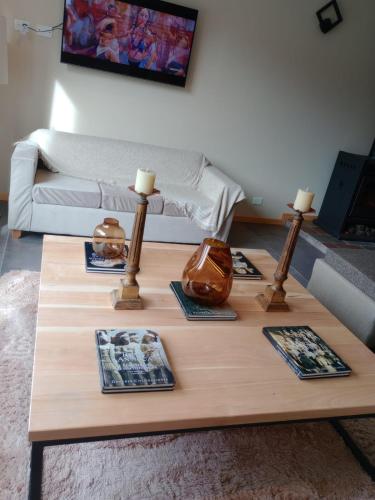 a living room with a coffee table with two lamps at Hostería Las Semillas in Villa La Angostura
