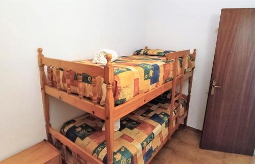 Katil atau katil-katil dalam bilik di Apartaments Les Dunes