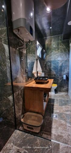 a bathroom with a shower with a sink and a toilet at Something Different in Nikšić
