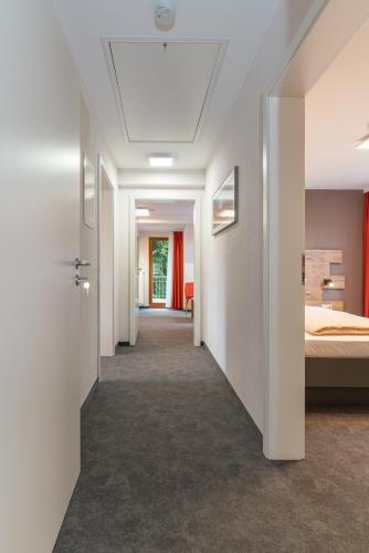 a hallway leading to a bedroom with a bed at Parkhotel Cochem in Cochem