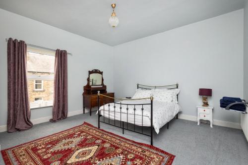 a bedroom with a bed and a rug and a window at Horbury High St Wakefield in Horbury