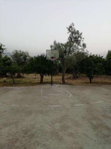 a basketball hoop in an empty parking lot at κτήμα ΝΟΣΤΟΣ in Aígio