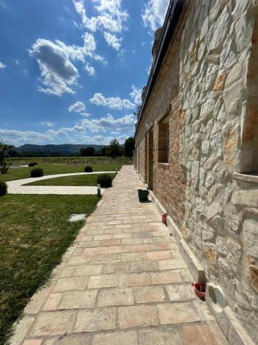 a brick building with a brick sidewalk next to a building at Agriturismo Tenuta Filippi in Narni