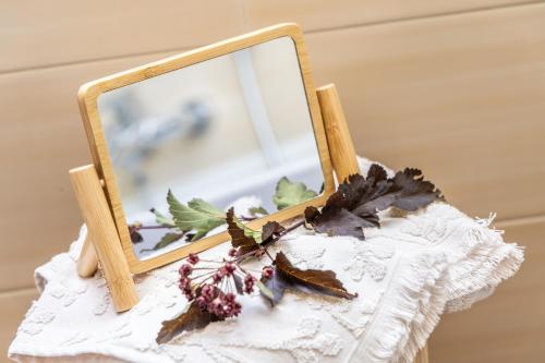 a mirror on a table with a white lace dress at Hotel Folgarida in Folgarida