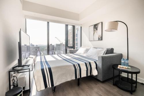 a bedroom with a bed and a large window at Traveller home in centre Toronto in Toronto