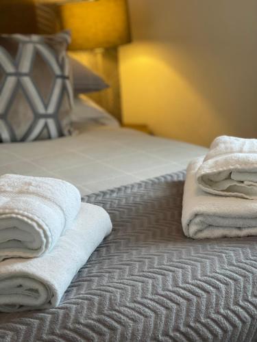a bed with towels sitting on top of it at The Upper Largo Hotel & Restaurant in Lundin Links