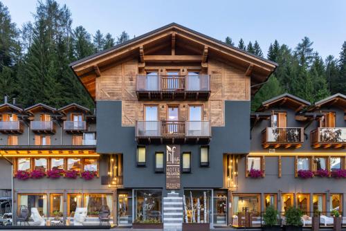 a hotel in the mountains with a building at Hotel Folgarida in Folgarida