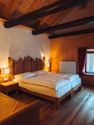 a bedroom with a large bed in a room at Malga Millegrobbe Nordic Resort in Lavarone