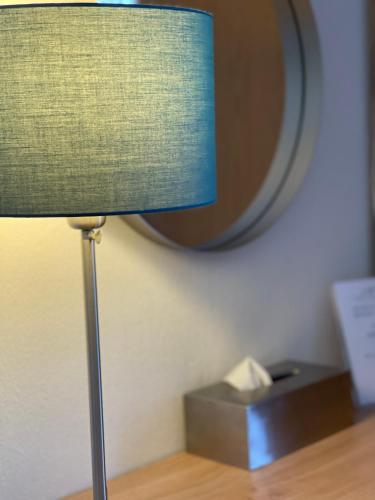 a lamp sitting on a table in front of a mirror at The Upper Largo Hotel & Restaurant in Lundin Links