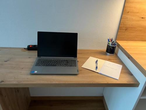 a laptop computer sitting on top of a wooden desk at Appartement NaMoll in Ausserfragant