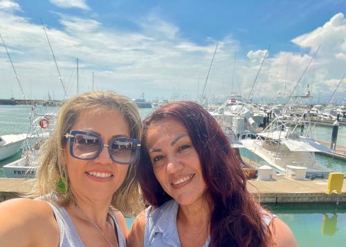 two women standing next to each other at a marina at Casa Paraiso Tropical in Parrita