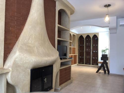 a living room with a fireplace and a brick wall at Como en casa 1 in Elche