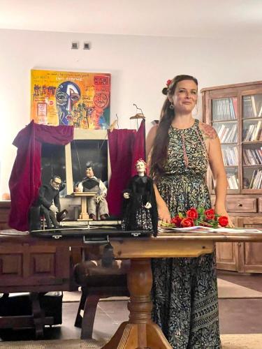 a woman is standing in front of a table with a table at Monte Do Malhao - Art, Eco & Spa in Castro Marim