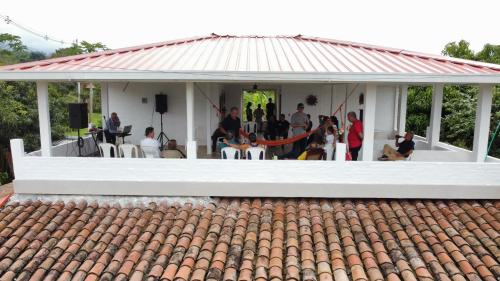 a group of people sitting in a white pavilion at Casa Blanca in Palmira