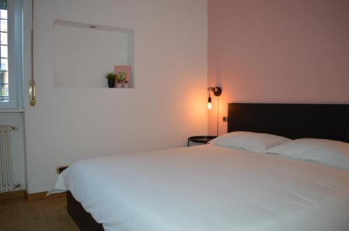 a bedroom with a white bed and a window at Domi - Appartamento Roma in Rome