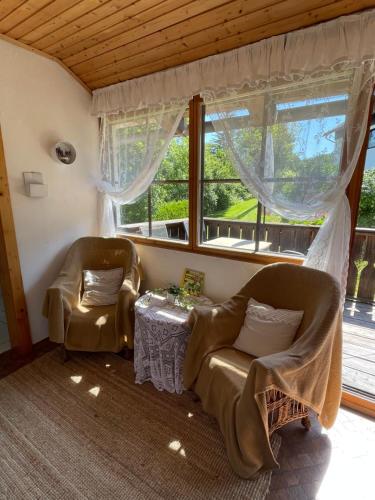 a living room with two chairs and a table at Apartments Wrolich in Latschach ober dem Faakersee