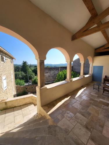 an indoor patio with arches and a view of the mountains at Les parfums du midi in Saint-Victor-de-Malcap