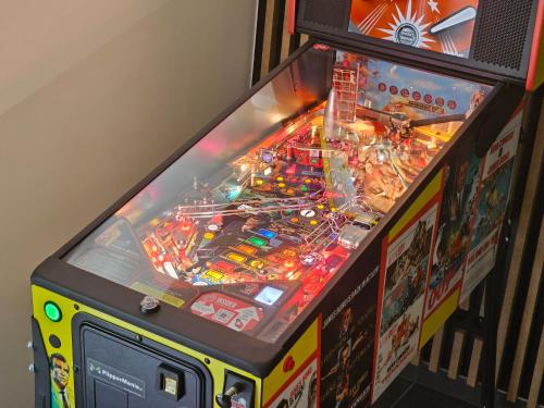a pinball game in a game room with a machine at Tatry Mozaika Willa PREMIUM & Sauna, Jacuzzi, Flipper by Rentilo in Zakopane