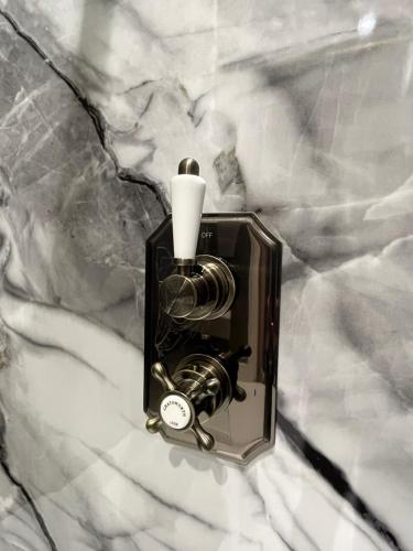 a black and white photo of a light on a marble counter at Château 9 Neuf in Newark upon Trent