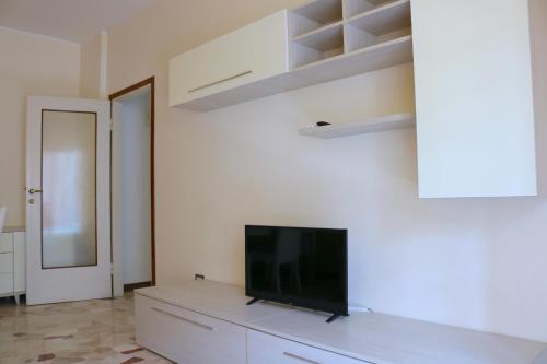 a living room with a flat screen tv on a dresser at Frattini Comfy family Home - 4 People in Milan