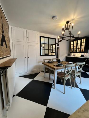 a dining room with a table and chairs on a checkered floor at Château 9 Neuf in Newark upon Trent
