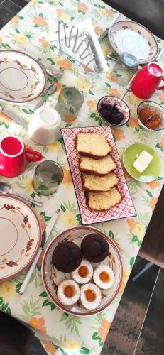 a table with plates of food on a floral table cloth at La Terra Buona guest house in Villa San Secondo