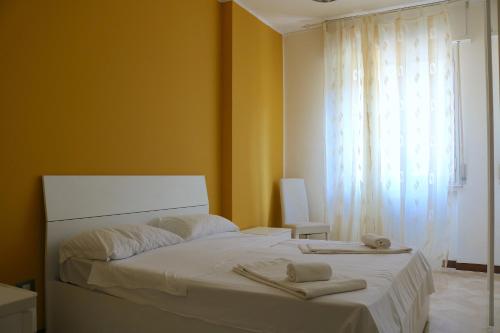 a bedroom with a white bed with towels on it at Frattini Comfy family Home - 4 People in Milan