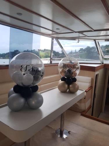two stuffed animals sitting on a table in a boat at Pousada Paraiso de Igaratá in Igaratá