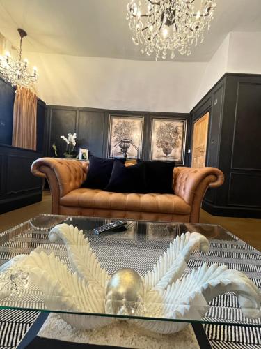 a living room with a couch and a glass table at Château 9 Neuf in Newark upon Trent