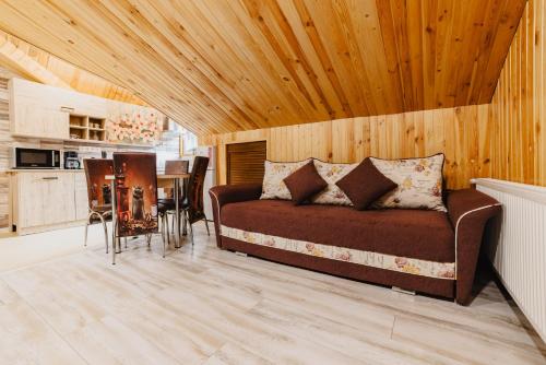 a living room with a couch and a table at Noua Oasis BNB with PARKING in Braşov
