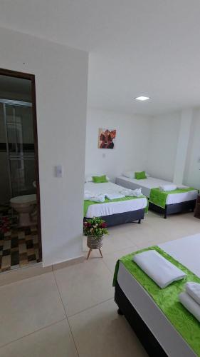 a room with three beds in a room at Ecohotel Linda Judith in Bahía Solano