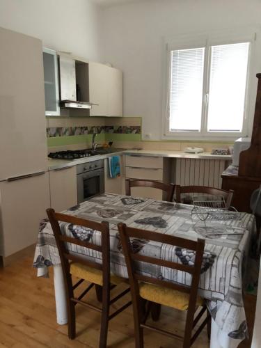 a kitchen with a table and some chairs and a table and a kitchen at la pigna bizantina in Ravenna