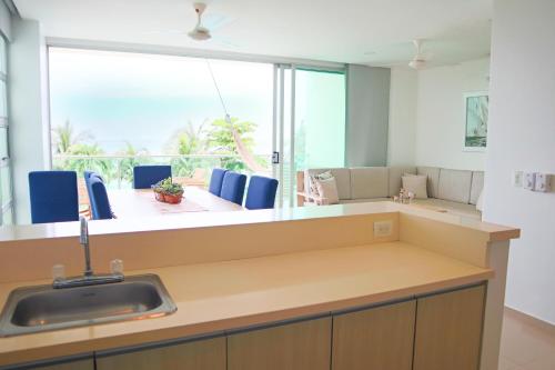 uma cozinha com um lavatório e uma grande janela em Magico Apartamento Frente al Mar 3 Habitaciones TR21 em Coveñas