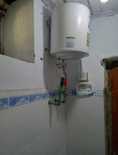 a bathroom with a sink and a toilet in a room at Siwakhat Huts in Shoghot