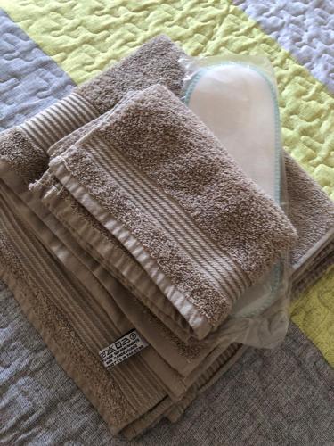 a pile of towels sitting on top of a bed at la pigna bizantina in Ravenna