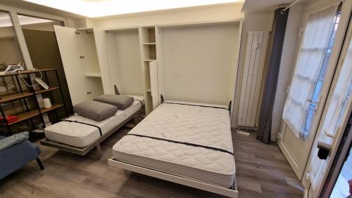 mały pokój z 2 łóżkami i kanapą w obiekcie Cozy apartment Milano Affori M3 w Mediolanie