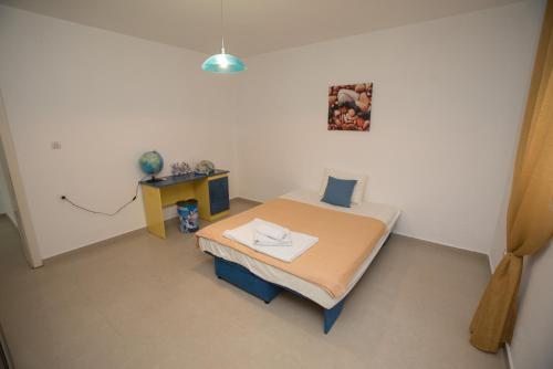 a hospital room with a bed and a table at Three Palms in Gevgelija