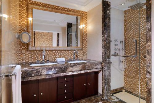 a bathroom with a sink and a shower with a mirror at Sheraton Cairo Hotel & Casino in Cairo