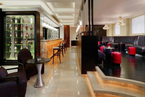 a restaurant with a bar and some tables and chairs at Sheraton Cairo Hotel & Casino in Cairo