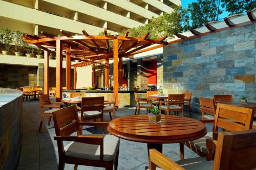 a restaurant with a wooden table and chairs at Sheraton Cairo Hotel & Casino in Cairo