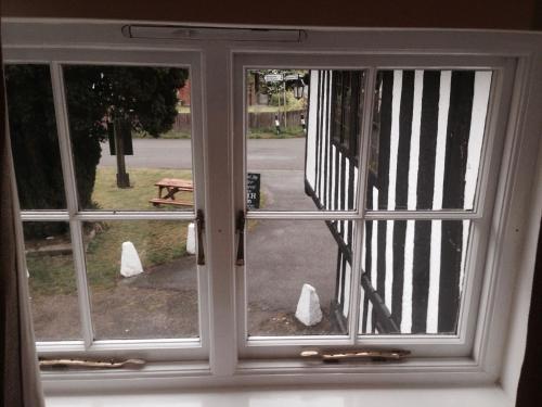 an open window with a view of a park at The Black Pig Public House in Staple