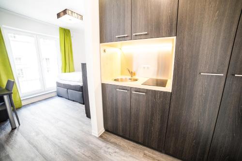 a bathroom with a sink and a toilet in a room at Luxstay Friedberg - Self-Check-In in Friedberg