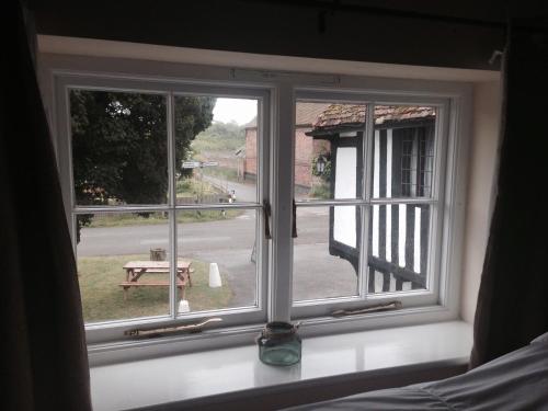 a window with a view of a picnic table at The Black Pig Public House in Staple