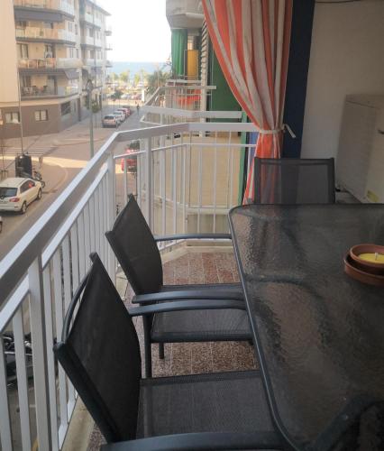 a balcony with a table and chairs and a street at Apartament LA SAL in Pineda de Mar