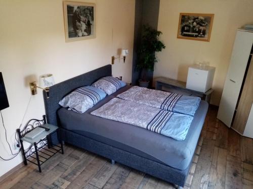 a bedroom with a blue bed in a room at Pension Hubertus in Oberraden