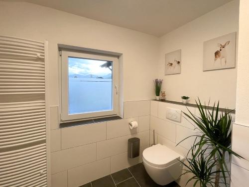 a bathroom with a toilet and a window at Haus Sabine in Leutasch