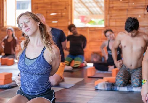 a group of people in a yoga class at Casa del Sol in Montañita